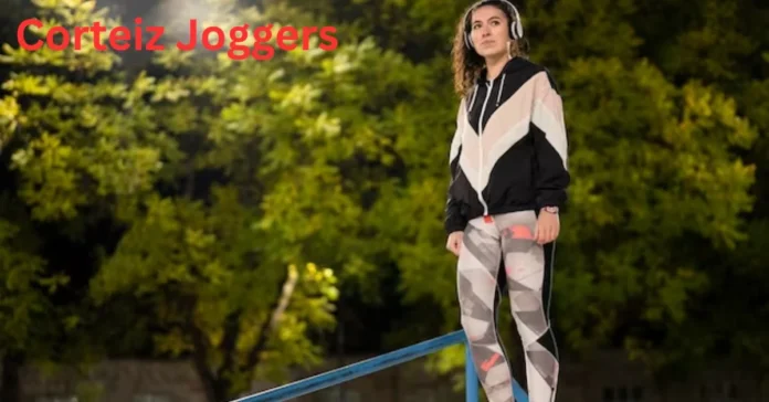 a person wearing headphones and standing on a railing corteiz joggers