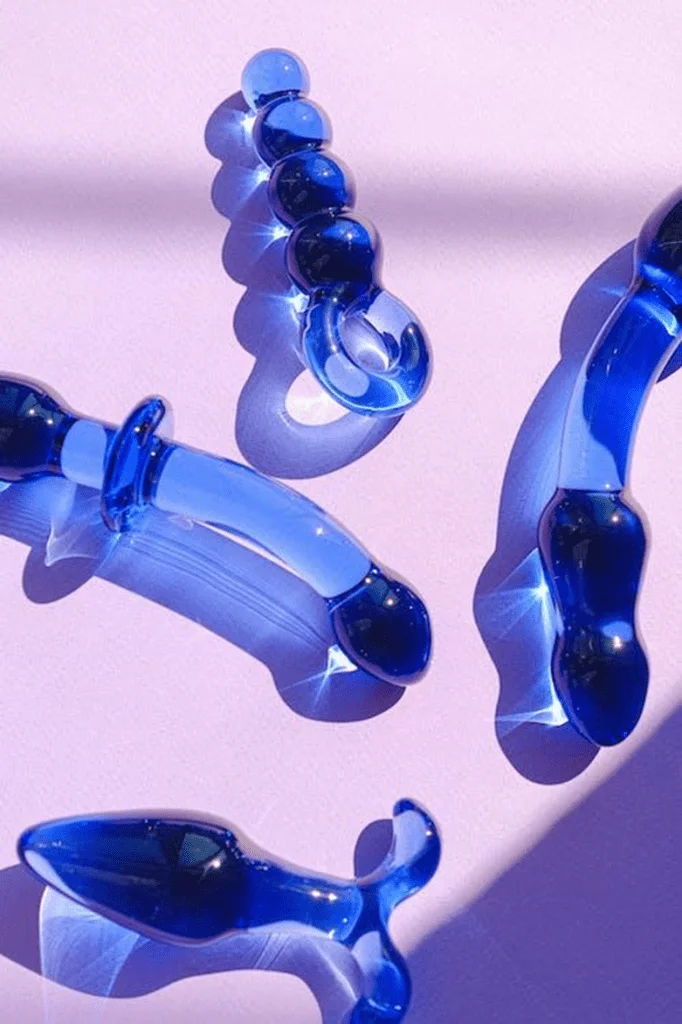blue glass objects on a pink surface