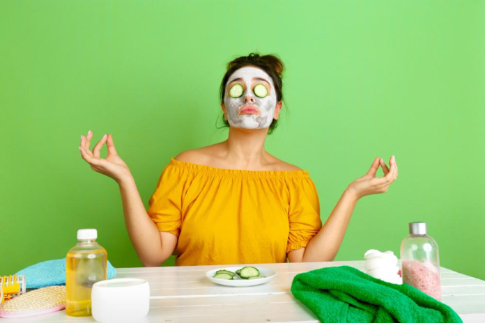 A lady with a protective face mask on, indulging in a pampering session with a cucumber mask applied to her face for revitalization. A lady with a protective face mask on, indulging in a pampering session with a cucumber mask applied to her face for revitalization. A lady with a protective face mask on, indulging in a pampering session with a cucumber mask applied to her face for revitalization.
